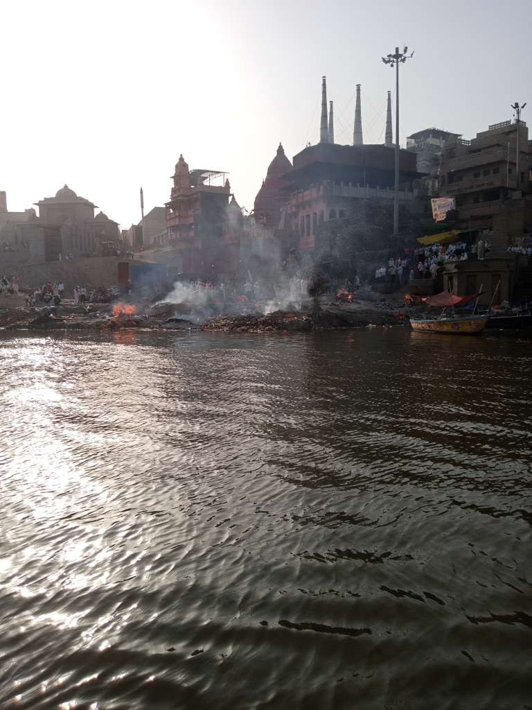 Manikarnika Ghat with pyres burning at the river's edge